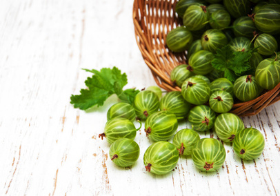 gooseberries with leaves on a old wooden background